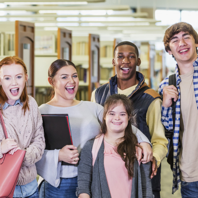 High school students in library, girl with down syndrome High school students in library, girl with down syndrome