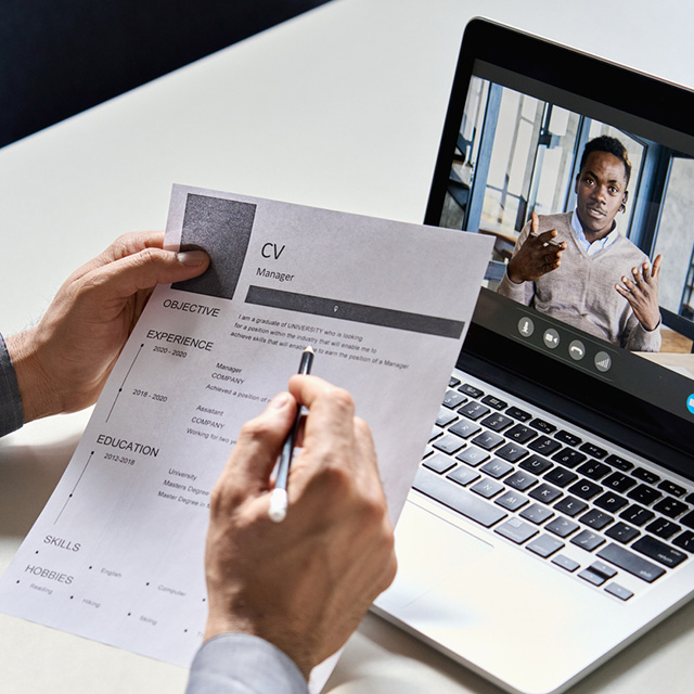 Person reviewing their resume in front of a computer