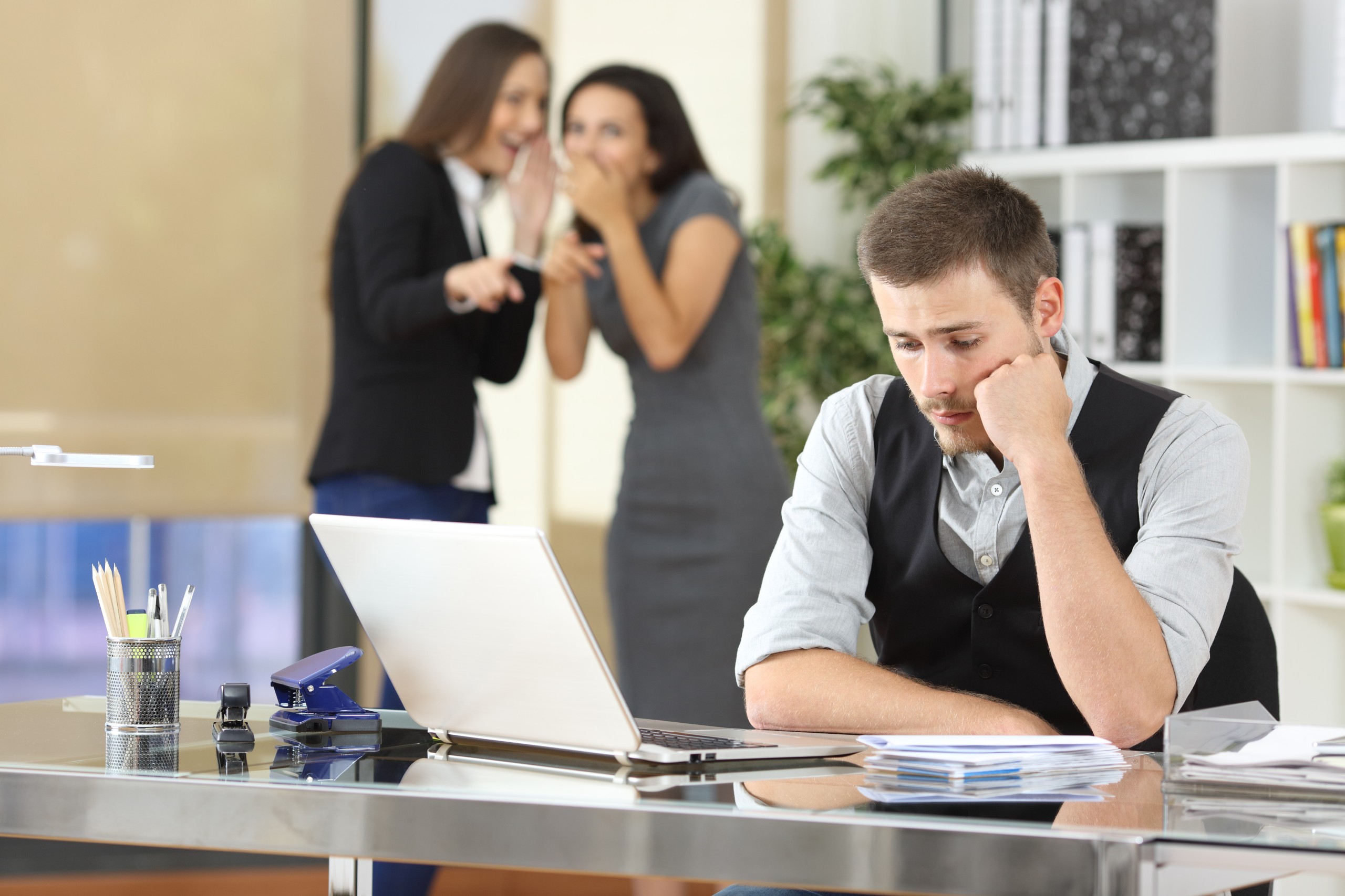 Workers bullying a colleague at office